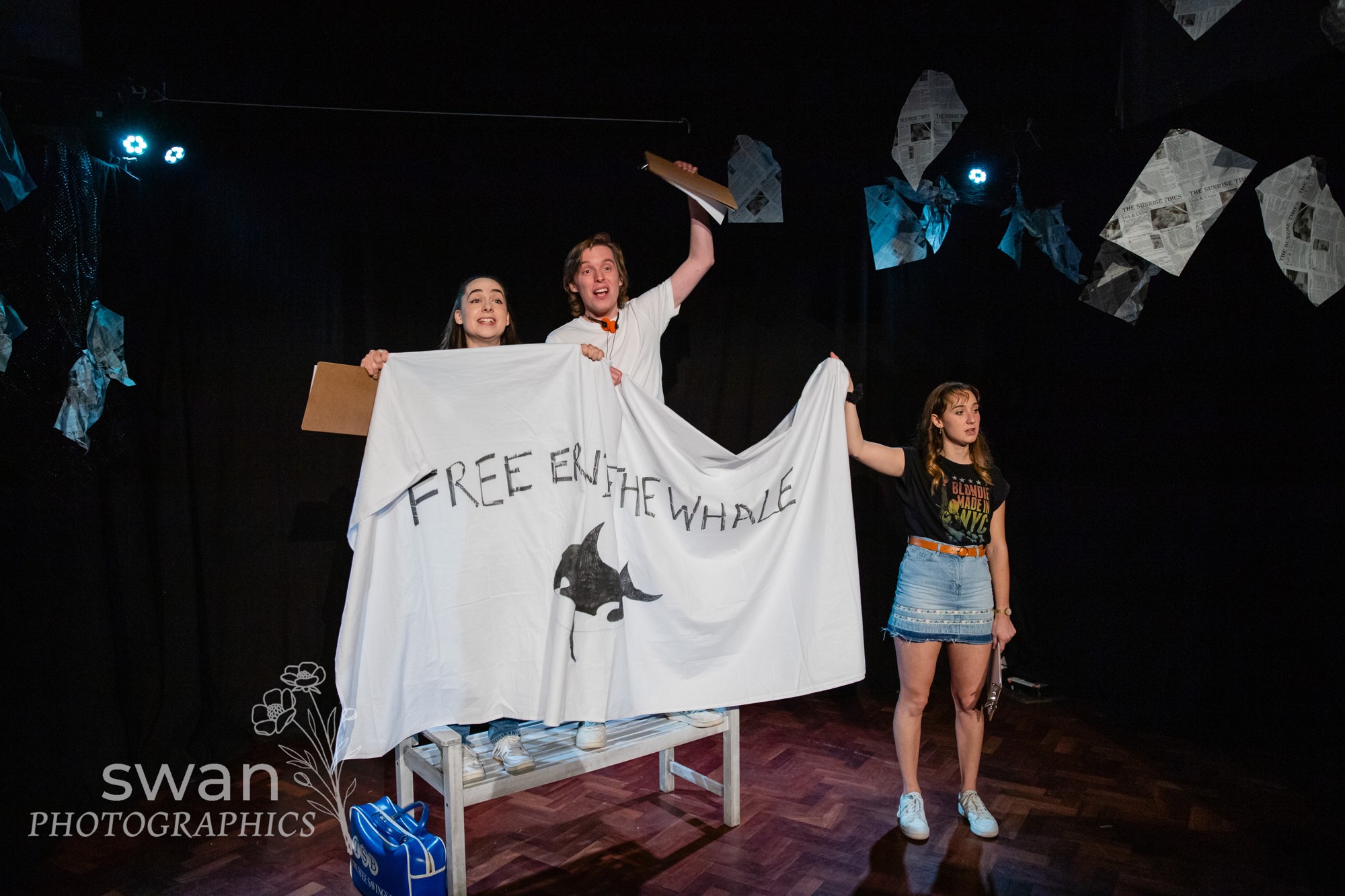 The Clacton Three ensemble holding a campaign banner